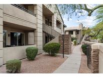 Well-maintained condo building with walkway and landscaping at 7009 E Acoma Dr # 2006, Scottsdale, AZ 85254