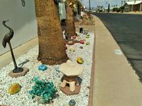 Ornamental yard with decorative rocks, sculptures, and palm trees at 8103 E Southern Ave # 287, Mesa, AZ 85208