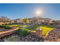Beautiful ranch home with brick accents and a lush, manicured lawn at 21391 E Orchard Ln, Queen Creek, AZ 85142