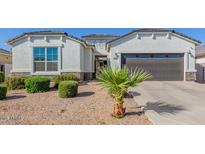 Single-story home with a two-car garage and desert landscaping at 38124 W Santa Barbara Ave, Maricopa, AZ 85138