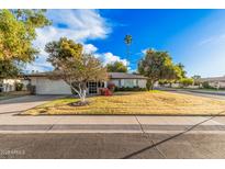 Single story home with landscaped yard and two car garage at 575 Leisure World --, Mesa, AZ 85206