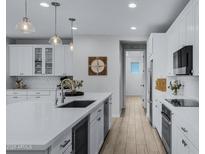 Open concept kitchen with island, stainless steel appliances, and white cabinets at 20865 E Timberline Rd, Queen Creek, AZ 85142