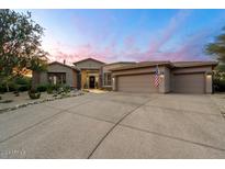 Stunning desert home with attractive landscaping and a three-car garage at 6450 E Bent Tree Dr, Scottsdale, AZ 85266