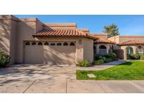 Spanish style home with a two car garage and lush landscaping at 11806 N 40Th Pl, Phoenix, AZ 85028