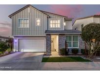 Two-story home with gray siding, stone accents, and a two-car garage at 1372 W Crane Dr, Chandler, AZ 85286