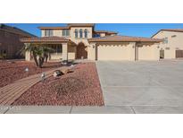 Two-story house with a three-car garage and landscaped front yard at 5124 W Gwen St, Laveen, AZ 85339