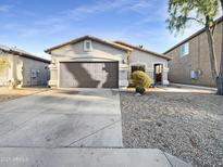 Single-story house with a two-car garage and desert landscaping at 521 E Cheyenne Rd, San Tan Valley, AZ 85143