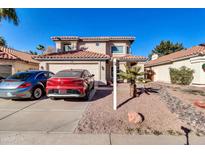 Two-story house with a two-car garage and desert landscaping at 910 W San Mateo Ct, Gilbert, AZ 85233