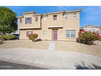 Two-story house with landscaped yard, and a purple door at 9706 N 82Nd Gln, Peoria, AZ 85345