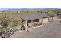 Ranch style home with covered porch, mountain views, and gravel driveway at 44824 N 10Th St, New River, AZ 85087