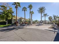 gated community entrance with palm trees at 7777 E 2Nd St # 111, Scottsdale, AZ 85251