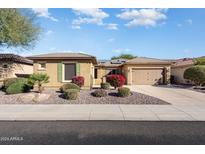 Single-story home with desert landscaping, two-car garage, and neutral color palette at 20283 N 273Rd Ave, Buckeye, AZ 85396