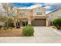 Two-story house with a large brown garage door and landscaping at 9567 W Robin Ln, Peoria, AZ 85383
