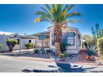 Single-wide manufactured home with carport and desert landscaping at 17200 W Bell Rd # 64, Surprise, AZ 85374