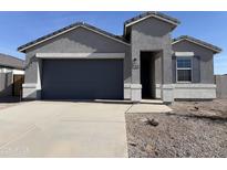 New gray stucco home with a two-car garage and desert landscaping at 18345 N San Juan St, Maricopa, AZ 85138