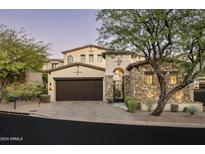 Stunning two-story home with stone accents and a three-car garage at 19501 N 101St St, Scottsdale, AZ 85255