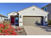 One-story house with red door, attached garage, and landscaping at 3372 W Stanton Ave, Apache Junction, AZ 85120