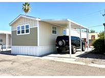 Single-wide manufactured home with carport and partial view of the neighborhood at 701 S Dobson Rd # 158, Mesa, AZ 85202