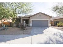 One-story house with gray garage door and landscaped front yard at 8575 W Maya Dr, Peoria, AZ 85383