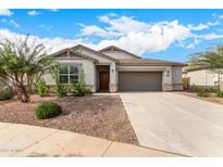 One-story house with a two-car garage and desert landscaping at 24686 N 184Th Ln, Wittmann, AZ 85361