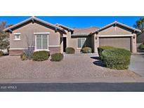 Single-story home with landscaped front yard and two-car garage at 7132 W Trenton Way, Florence, AZ 85132