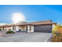 Ranch-style home with a two-car garage and well-maintained landscaping at 8039 E Madero Ave, Mesa, AZ 85209