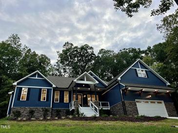 Stunning two-story home with a stone and blue siding exterior at 1350 Geneva Albright Rd, Graham, NC 27253