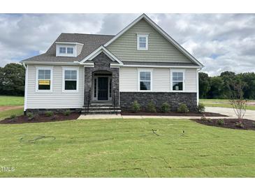 Charming two-story home with stone accents and a welcoming front porch at 73 Sage Ln # 008, Four Oaks, NC 27524