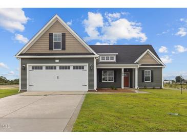 Two-story house with a two-car garage and gray siding at 152 Hillwood Dr, Sanford, NC 27332