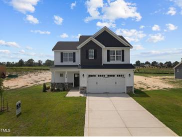 Two-story house with a two car garage and front yard at 114 Hillwood Dr, Sanford, NC 27332