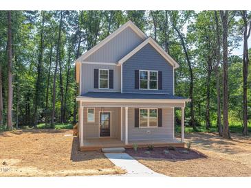 Two-story house with gray and blue siding, front porch and landscaping at 206 Cardinal Ct, Oxford, NC 27565