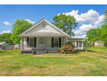 White house with a green lawn, showcasing classic architecture at 317 Quintas Ave, Burlington, NC 27215