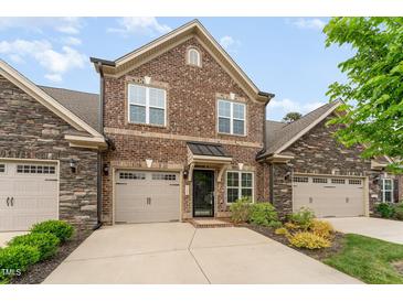 Brick front exterior of charming townhome with two-car garage at 1121 Talisker Way, Burlington, NC 27215