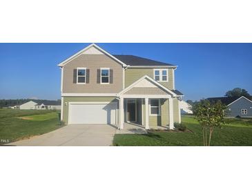 Two-story house, green and beige exterior, two-car garage at 191 Robert Howe Dr, Fuquay Varina, NC 27526