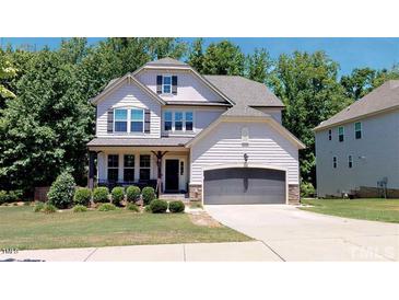 Two-story home with gray siding and a two-car garage at 104 Abbeville Ln, Holly Springs, NC 27540