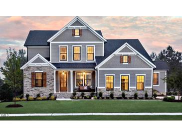 Stunning two-story home with stone accents and a manicured lawn at 4213 Burlington Mills Rd, Wake Forest, NC 27587