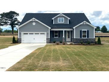 Two-story home with gray siding, white garage door, and stone accents at 246 Gin Branch Road, Wendell, NC 27591