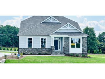Newly built craftsman style home with gray siding and stone accents at 117 Ausban Rdg Ln # 034, Four Oaks, NC 27524