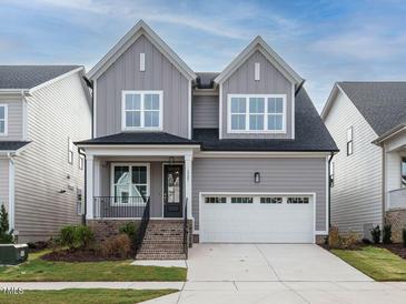 Charming two-story home with a gray exterior, white trim, and attached garage at 1721 Grassy Falls Ln, Wendell, NC 27591