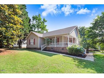 Ranch style home with front porch and landscaped lawn at 221 Southerby Dr, Garner, NC 27529