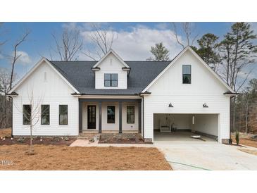 Modern farmhouse exterior with white siding and dark accents at 1690 Terry Rd, Durham, NC 27712