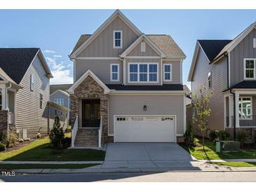 Two-story home with a neutral color scheme and two-car garage at 1719 Grassy Falls Ln, Wendell, NC 27591