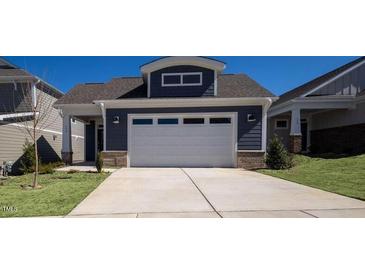Two-story home with gray siding and a white garage door at 154 Swain St, Clayton, NC 27527