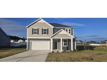 Two-story home with gray siding, white garage door, and landscaping at 466 Saint Clair Dr, Fuquay Varina, NC 27526