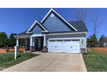 Charming craftsman style home with gray siding, white trim, and two-car garage at 3102 Castlerock Dr # 2, Burlington, NC 27215