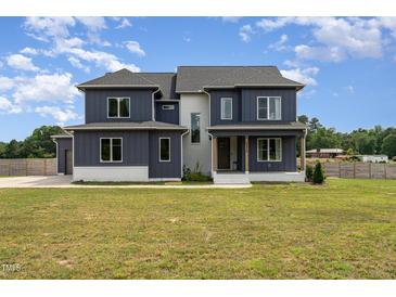 Two story home with dark siding, white accents, and a large yard at 6920 Will Let Ln, Wake Forest, NC 27587