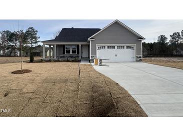 Gray exterior house with a two-car garage and a small front yard at 106 Burnello Ct, Princeton, NC 27569