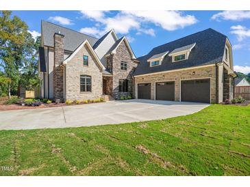 Brick house with three car garage and landscaped lawn at 109 November Dr, Durham, NC 27712