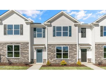 Two story townhome with stone accents and a teal door at 859 Old Tarboro Rd, Wendell, NC 27591