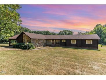 Ranch style home with stone and wood siding at 8450 Perry Rd, Graham, NC 27253